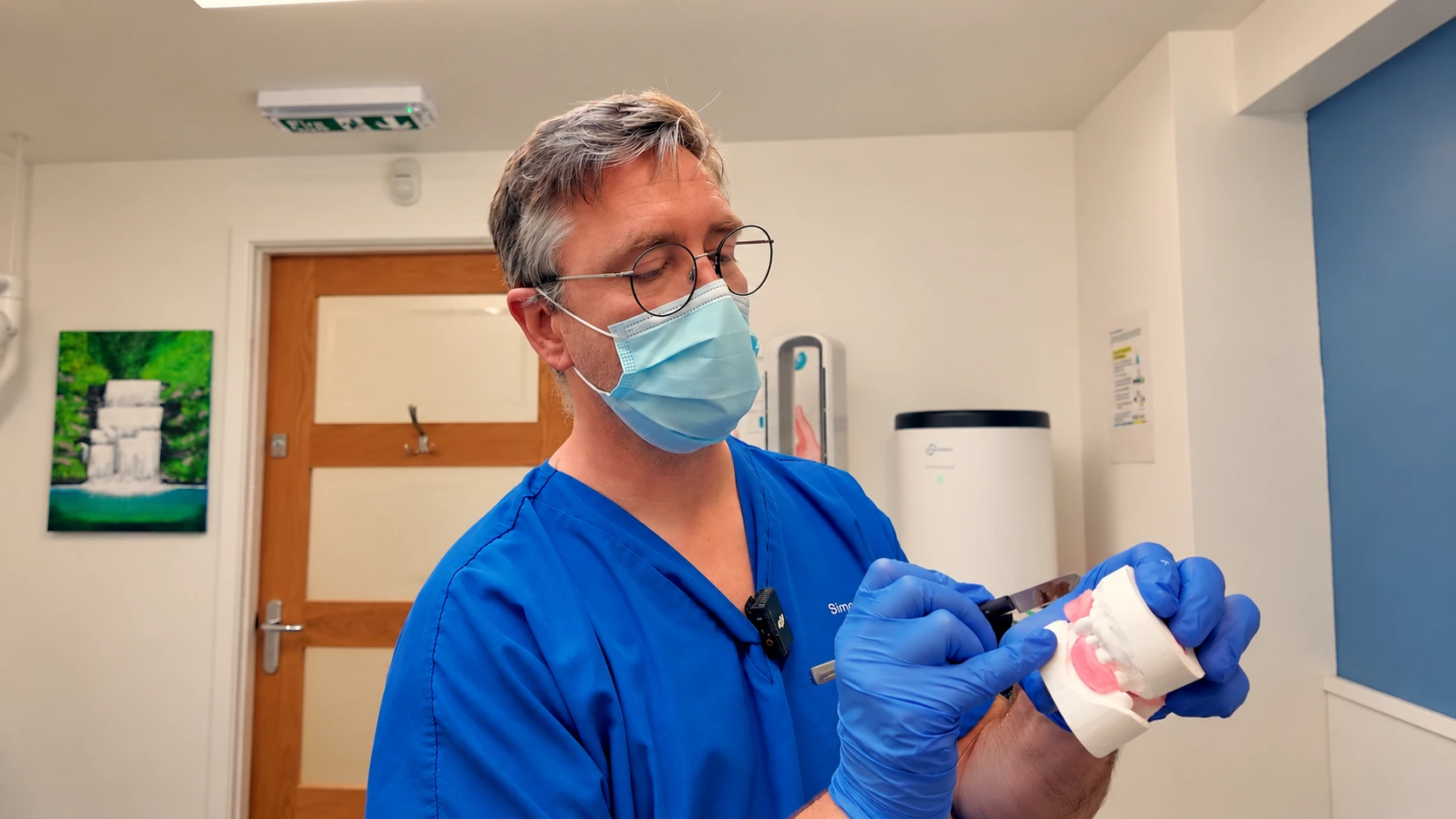 Simon Miles demonstrating a denture on a dental model in the clinic